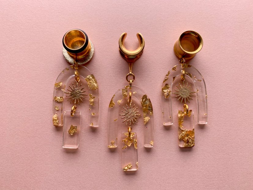 Gold Adorned Acrylic U-Shaped Earrings With Sun Pendant