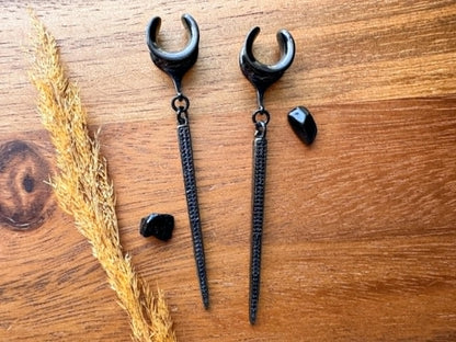Black CZ spike plug earrings with sparkling cubic zirconia accents and dangling spikes for stretched ears.