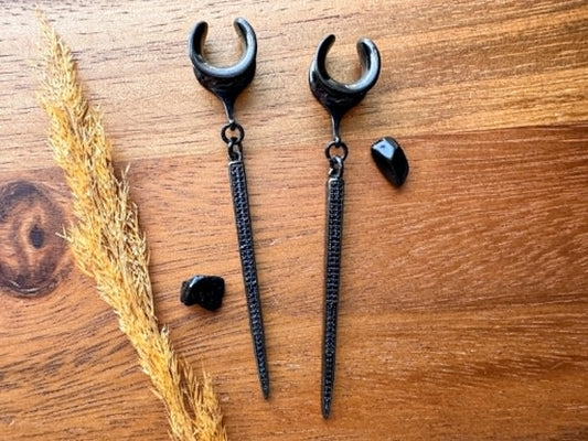 Black CZ spike plug earrings with sparkling cubic zirconia accents and dangling spikes for stretched ears.