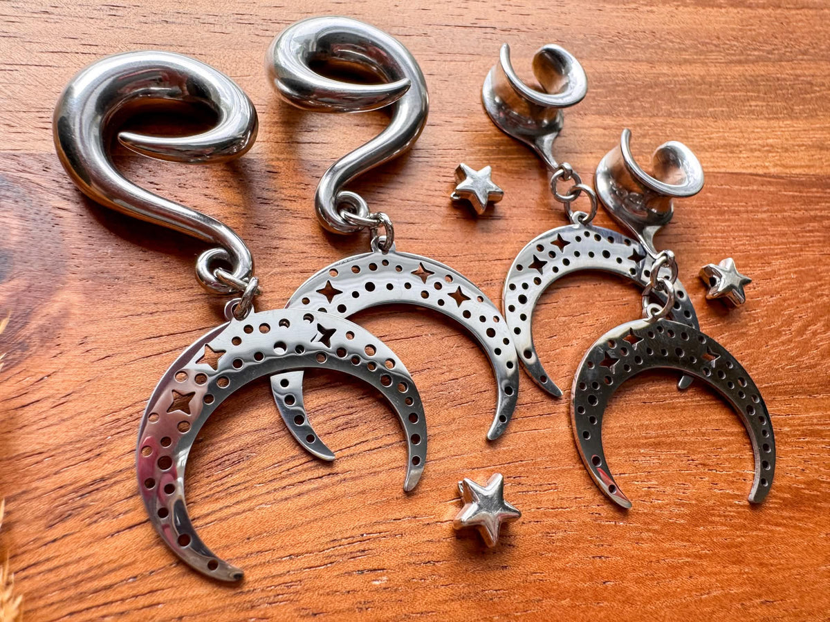 Cosmic Crescent Dangles featuring celestial crescent moon charms on dangling plug earrings for stretched ears.