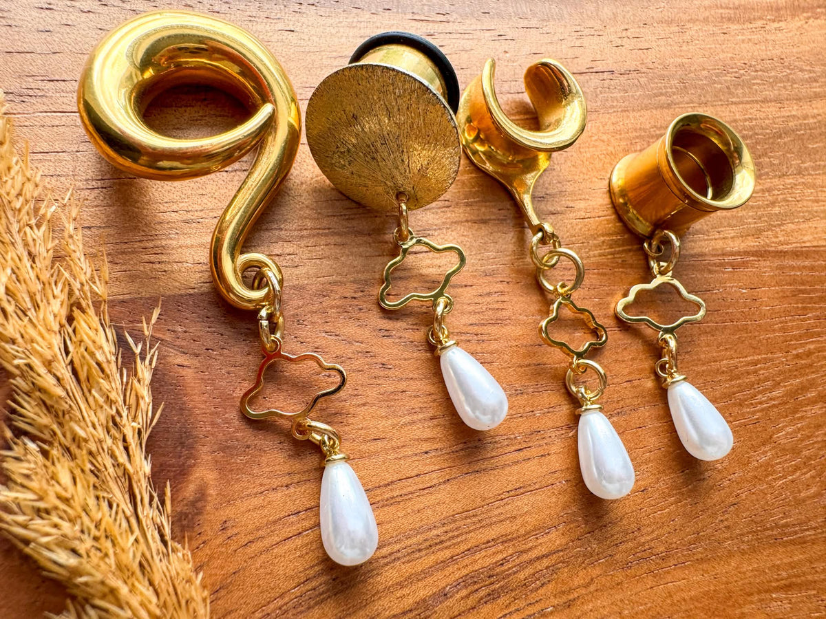 Gold Cloud Nine Pearls dangling plug earrings featuring delicate pearl accents and gold-tone details for stretched ears.