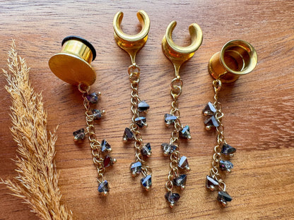 Gold smoky crystal plug earrings with cascading faceted crystal beads and dangling chains for stretched ears.