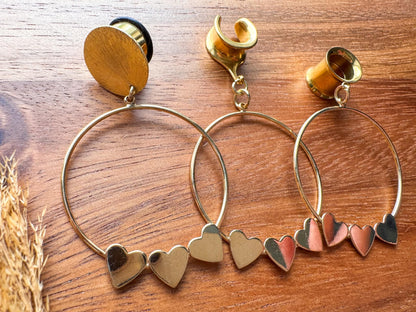 Gold Hearts in a Row hoop plug earrings featuring a row of romantic heart-shaped details in warm gold tones for stretched ears.