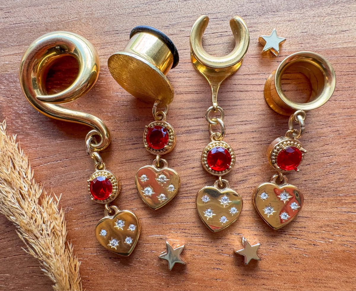 Gold Love Struck dangling plug earrings featuring romantic heart-shaped details for stretched ears.