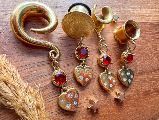 Gold Love Struck dangling plug earrings featuring romantic heart-shaped details for stretched ears.