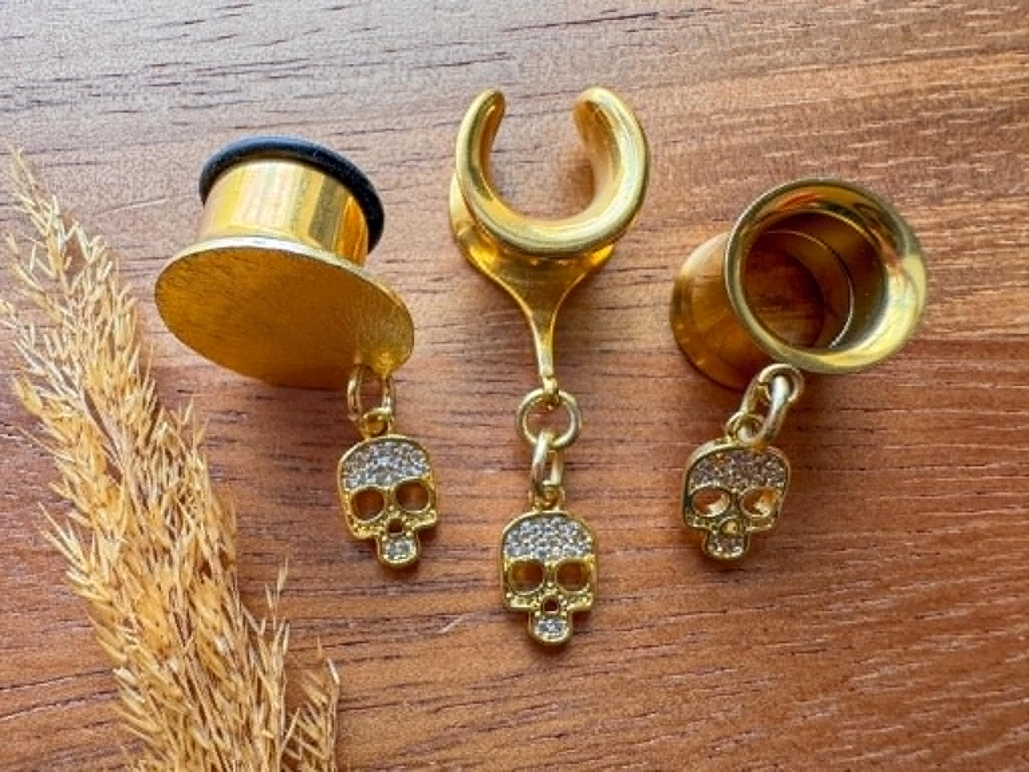 Gold mini skull plug earrings with sparkling zircon accents for stretched ears.
