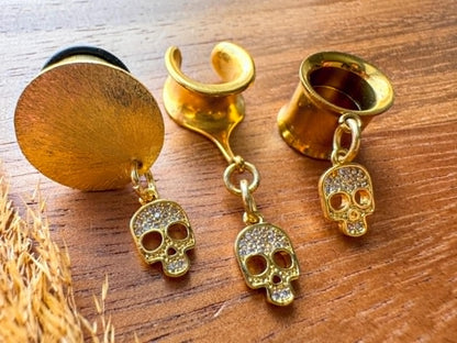 Gold mini skull plug earrings with sparkling zircon accents for stretched ears.