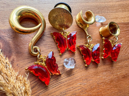 Gold and red butterfly dangling plug earrings featuring vibrant red butterfly details and gold-tone accents for stretched ears.