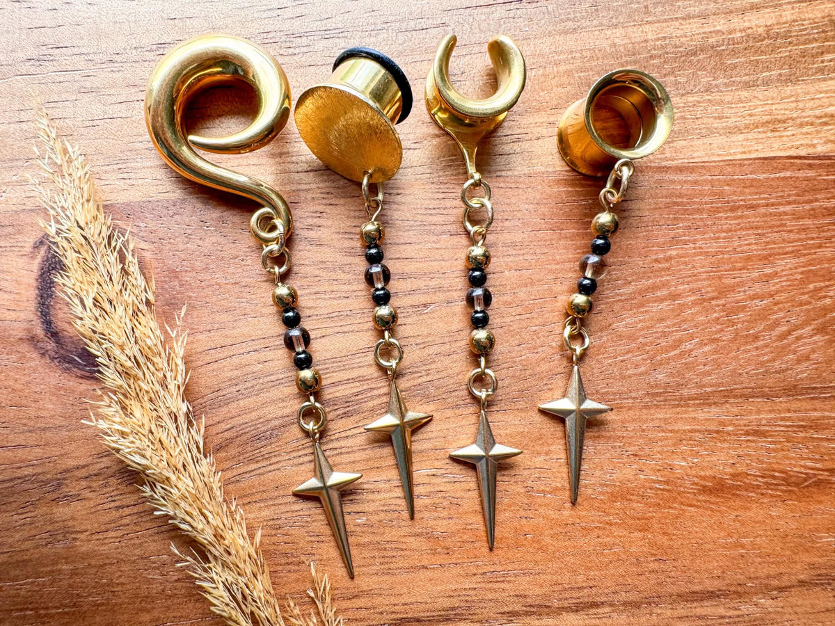 Gold Stardust & Shadows celestial-inspired dangling plug earrings for stretched ears.