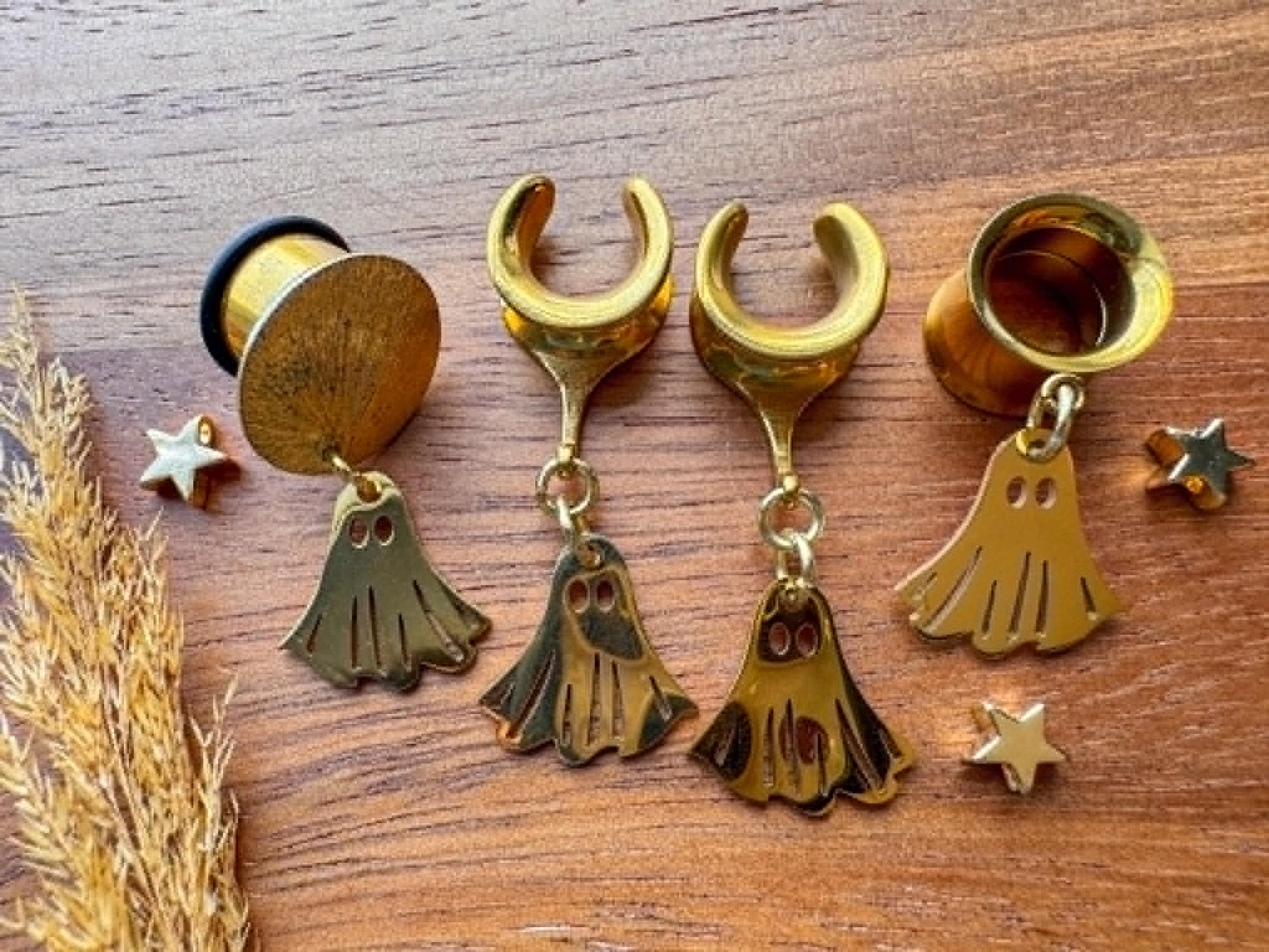 Gold stainless steel ghost plug earrings with mini ghost dangling charms for stretched ears.