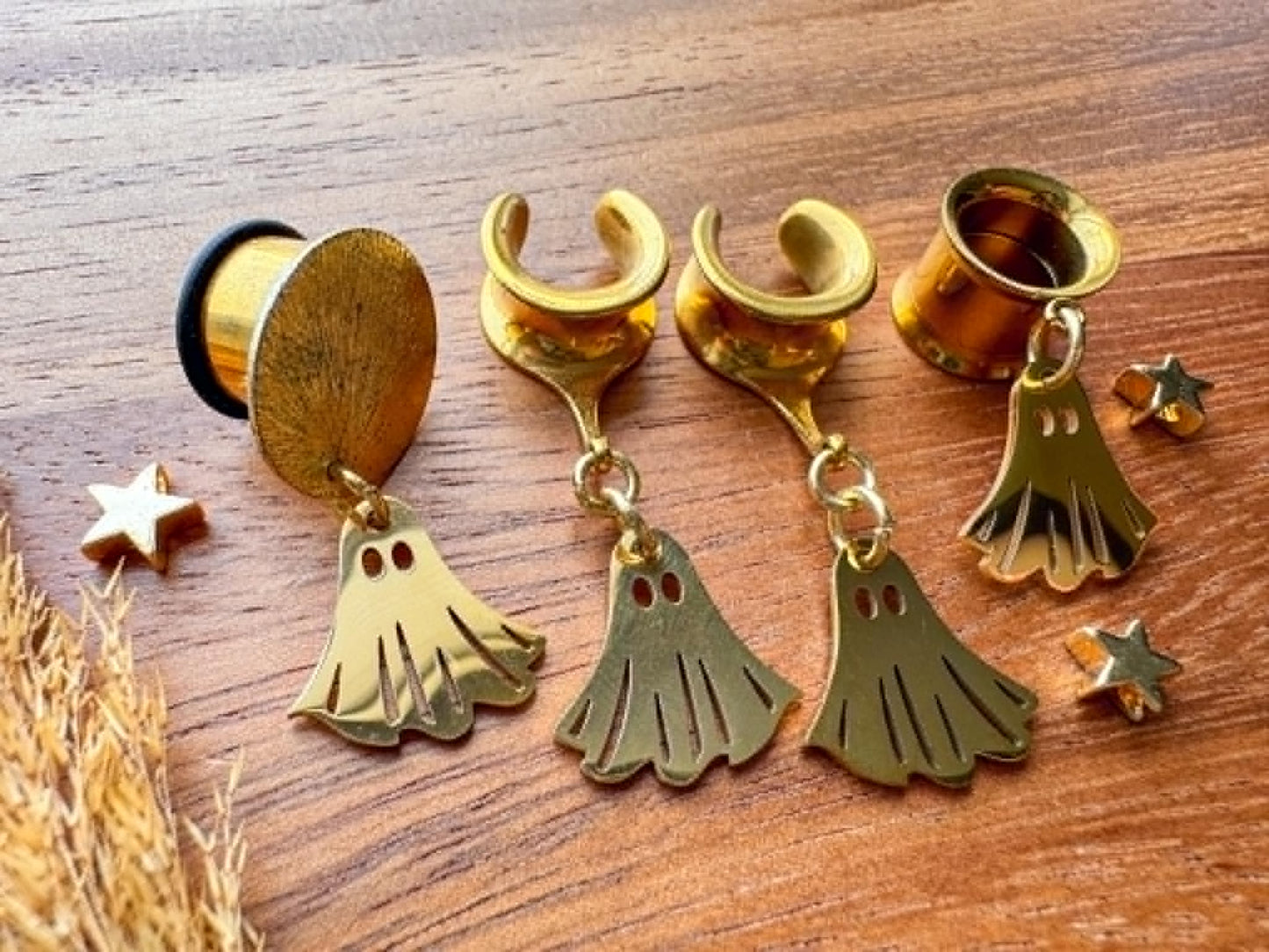 Gold stainless steel ghost plug earrings with mini ghost dangling charms for stretched ears.