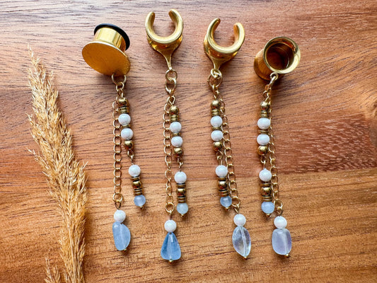 Gold ocean inspired plug earrings with dangling seaside details for stretched ears.