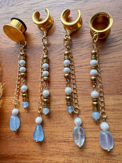 Gold ocean inspired plug earrings with dangling seaside details for stretched ears.
