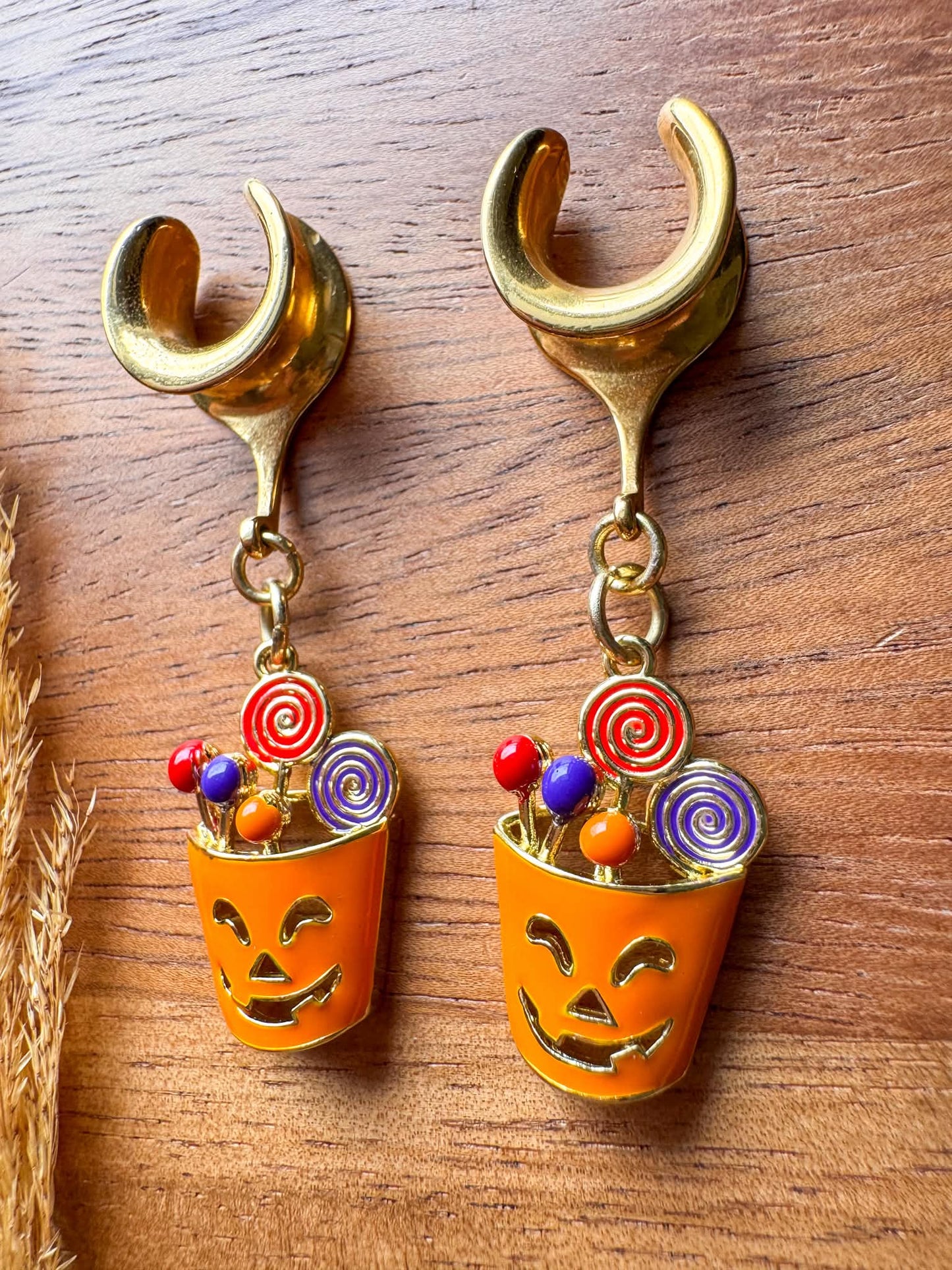 Gold Halloween treat basket plug earrings with dangling candy basket charms for stretched ears.