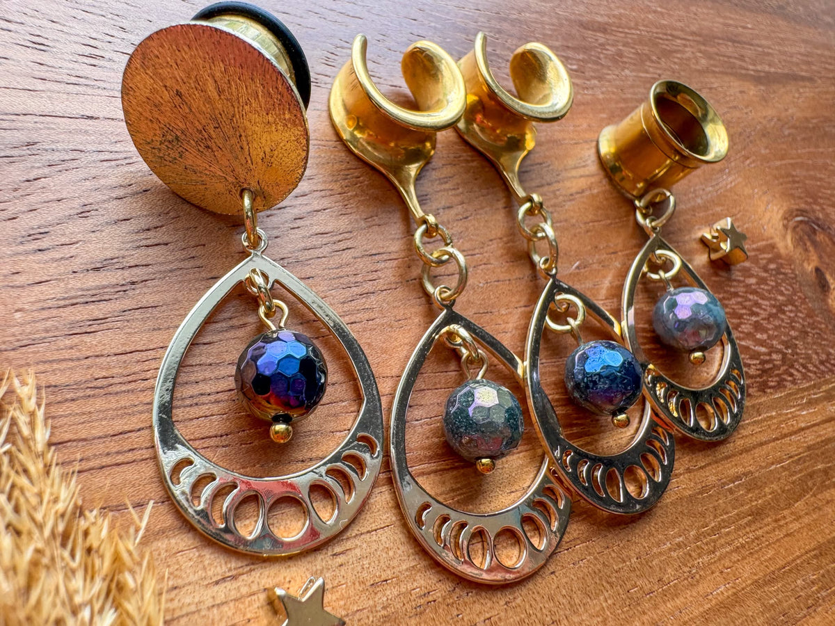 Gold iridescent teardrop plug earrings with faceted multicolor beads and intricate openwork frames for stretched ears.