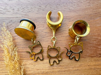 Golden stainless steel cat plug earrings with dangling cat charms for stretched ears.