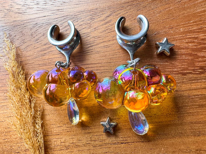 Orange and silver iridescent raincloud plug earrings with shimmering dangling details for stretched ears.