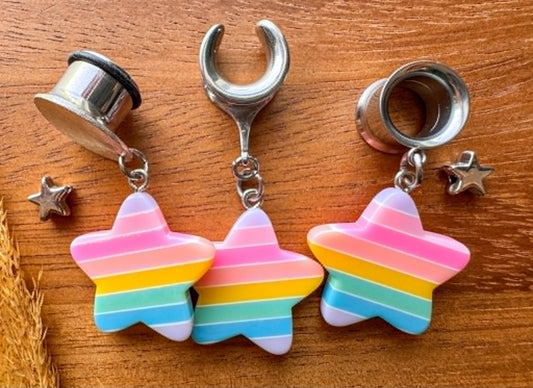 Pastel rainbow star plug earrings with colorful celestial charms for stretched ears.