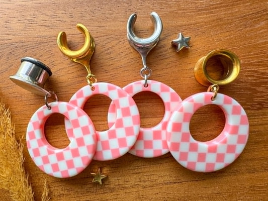 Pink and white checkered hoop plug earrings with a retro checkerboard pattern for stretched ears.