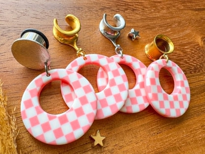 Pink and white checkered hoop plug earrings with a retro checkerboard pattern for stretched ears.