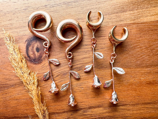 Rose gold plated rose dangling plug earrings featuring romantic floral details and a warm rose gold finish for stretched ears.