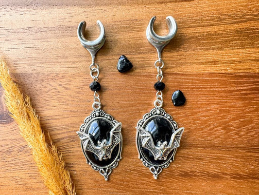 Silver and black bat crest plug earrings with gothic bat dangles for stretched ears.