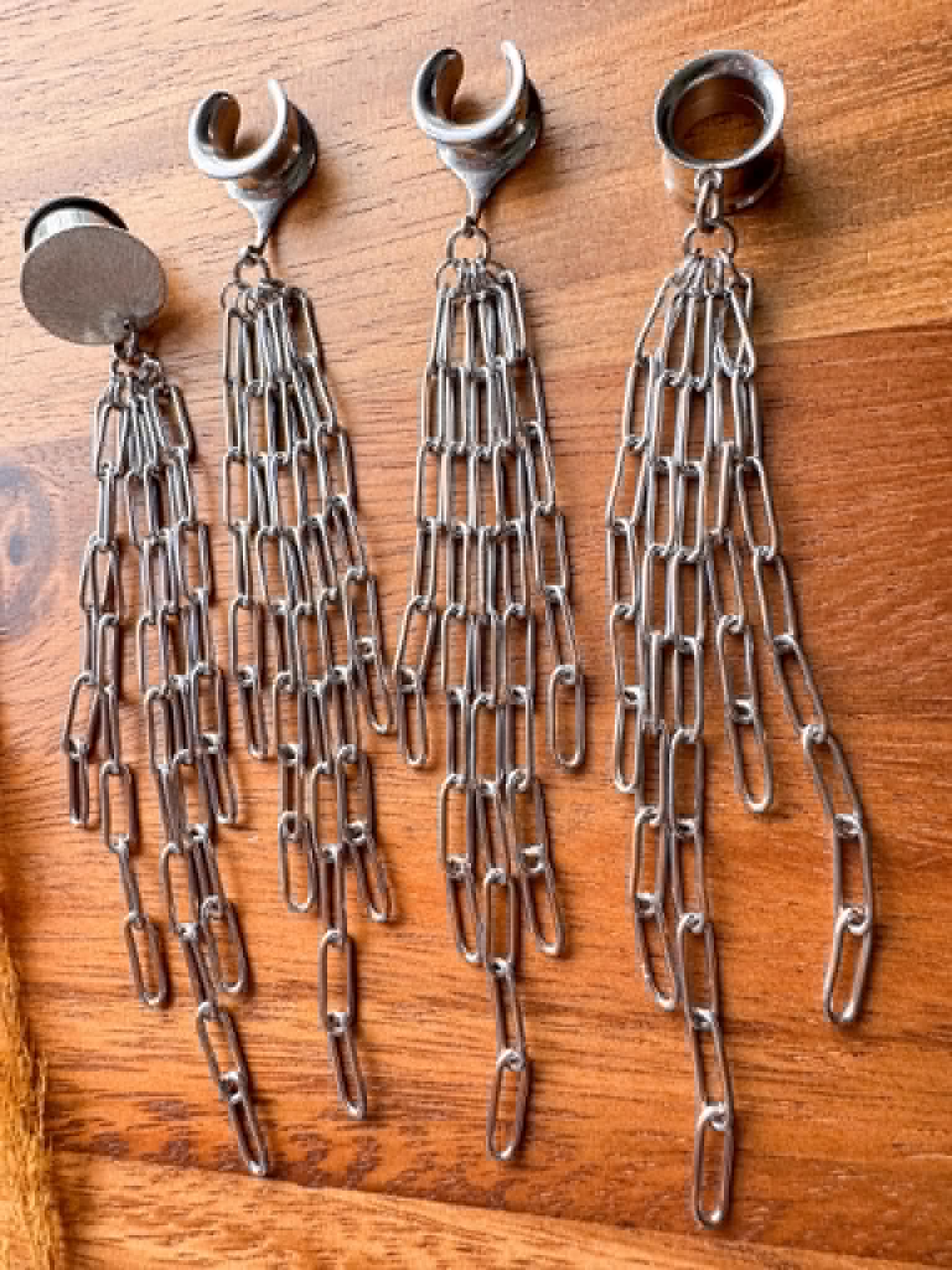 Silver chain plug earrings with long dangling chain accents for stretched ears.