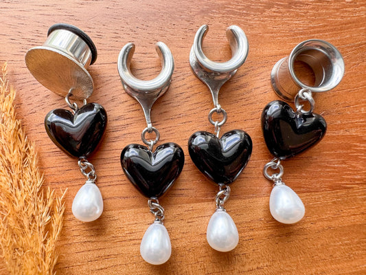 Silver black heart plug earrings with glossy heart charms and dangling white faux pearls for stretched ears.