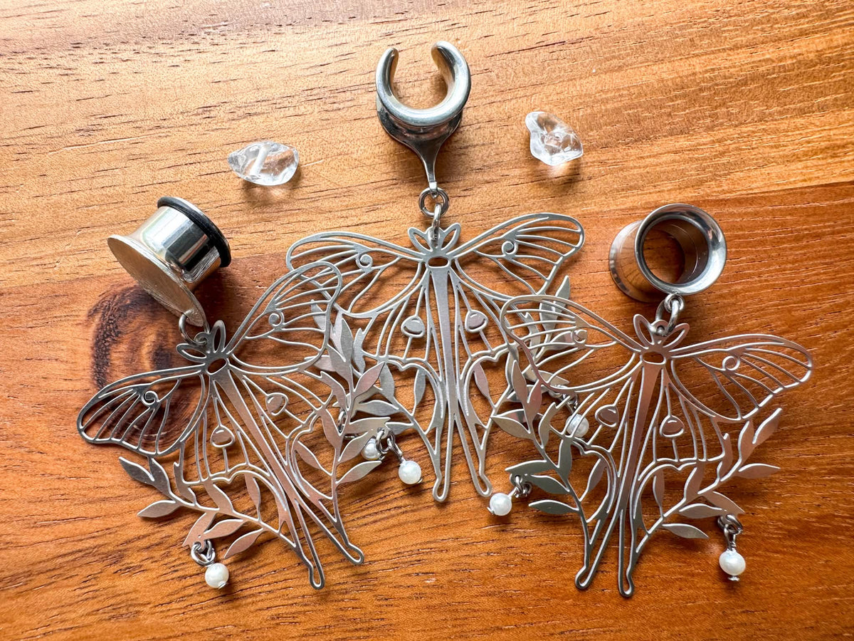 Silver moth plug earrings with whimsical woodland-inspired details for stretched ears.