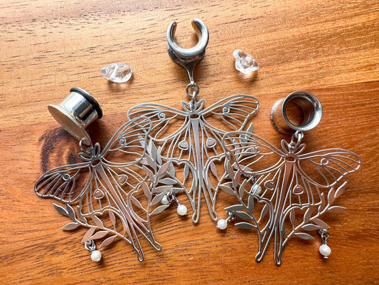 Silver moth plug earrings with whimsical woodland-inspired details for stretched ears.