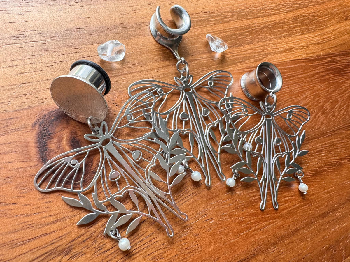 Silver moth plug earrings with whimsical woodland-inspired details for stretched ears.