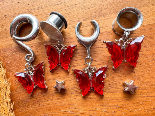 Silver and red butterfly dangling plug earrings featuring vibrant red butterfly details and silver-tone accents for stretched ears.