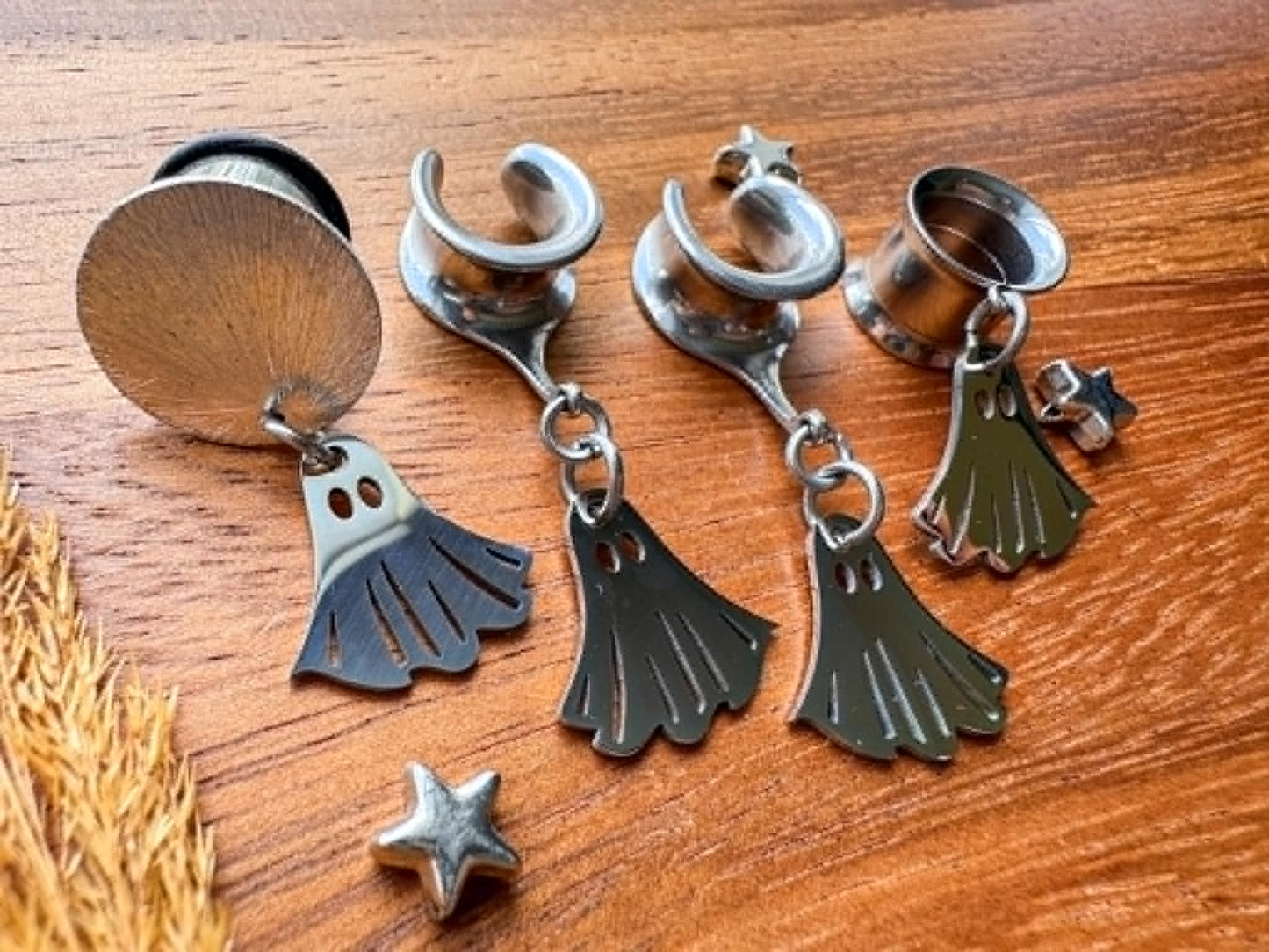 Silver stainless steel ghost plug earrings with mini ghost dangling charms for stretched ears.