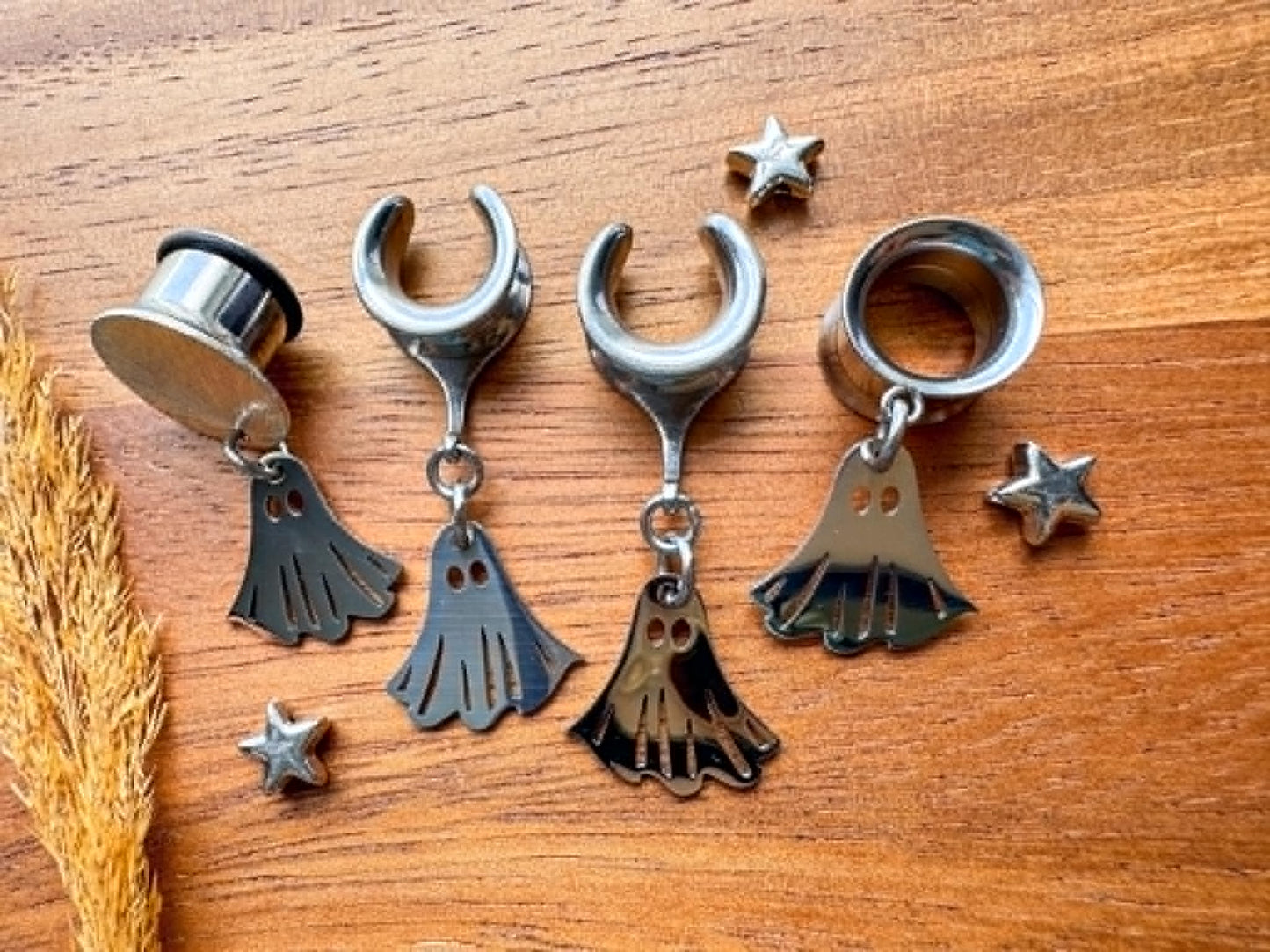 Silver stainless steel ghost plug earrings with mini ghost dangling charms for stretched ears.