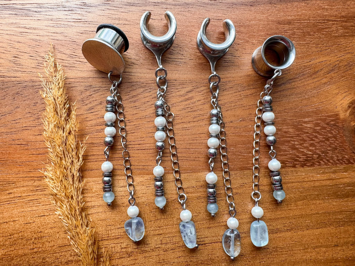 Silver ocean inspired plug earrings with dangling seaside details for stretched ears.