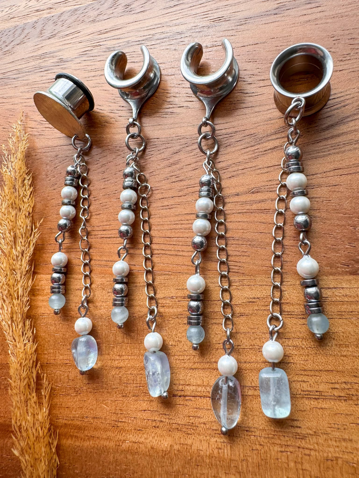 Silver ocean inspired plug earrings with dangling seaside details for stretched ears.