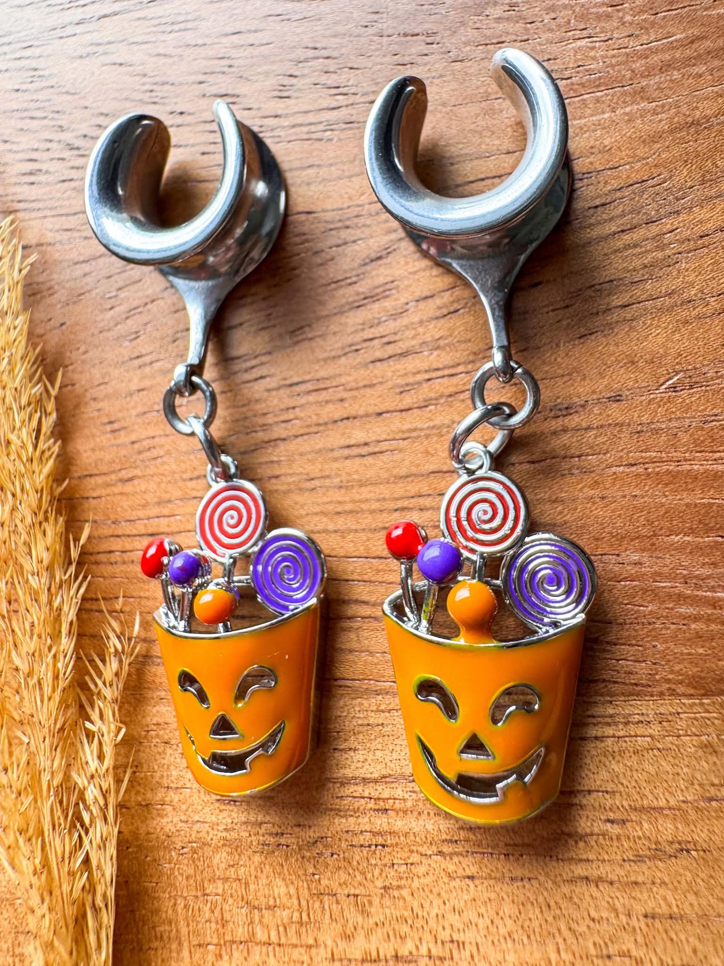 Silver Halloween treat basket plug earrings with dangling candy basket charms for stretched ears.