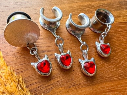 Silver and red devil heart plug earrings with dangling heart charms for stretched ears.