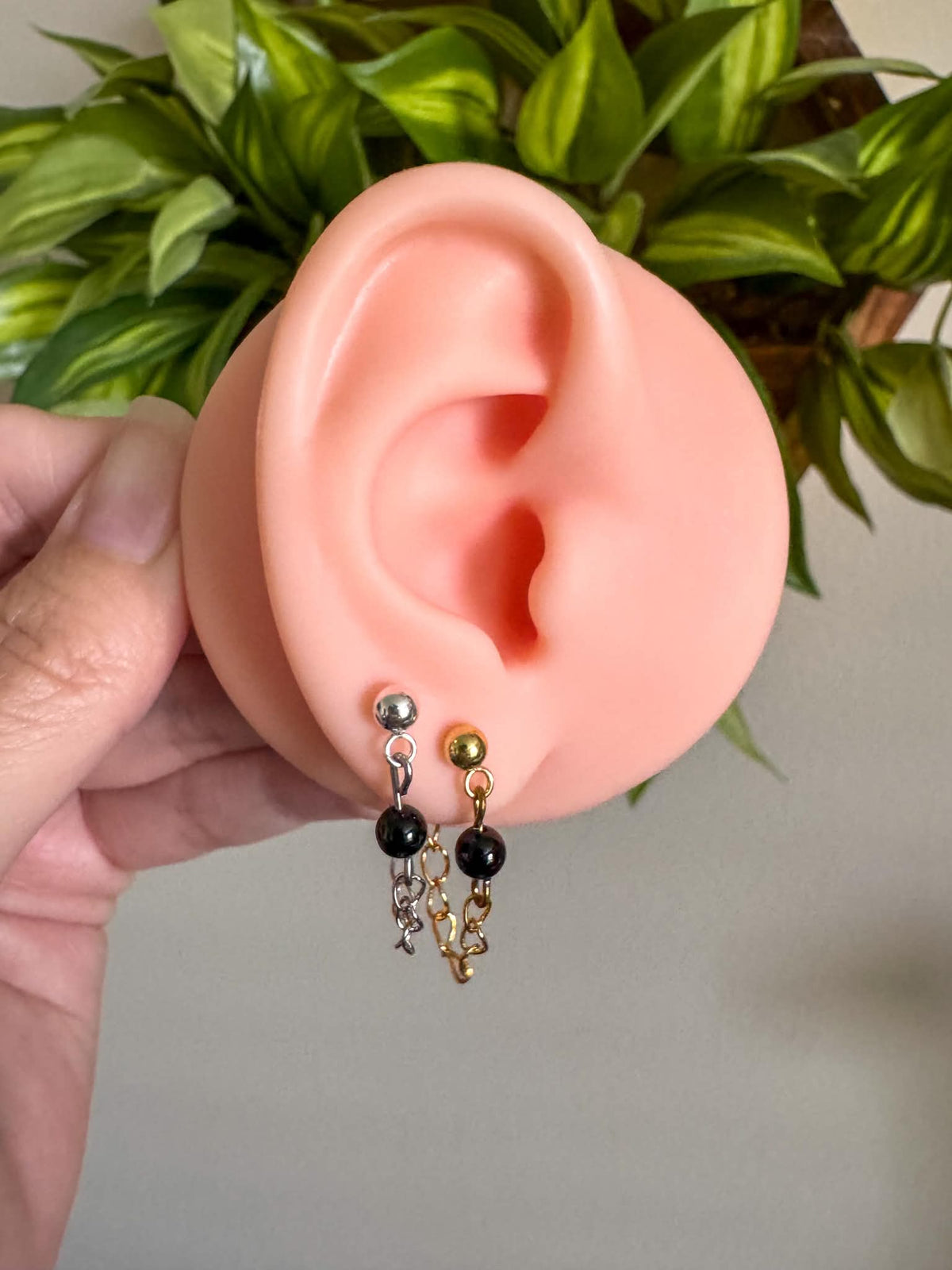 Silver or gold chain ball post earrings with dangling chains and black onyx details.