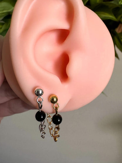 Silver or gold chain ball post earrings with dangling chains and black onyx details.