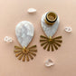 White Marble Acetate Dangle With Gold Brushed Sunburst